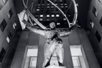 A black and white fine art photo of the famous Art Deco statue of Atlas at Rockefeller Center illuminated at night, New York City. Fine art prints of this photo are available framed in various styles. 