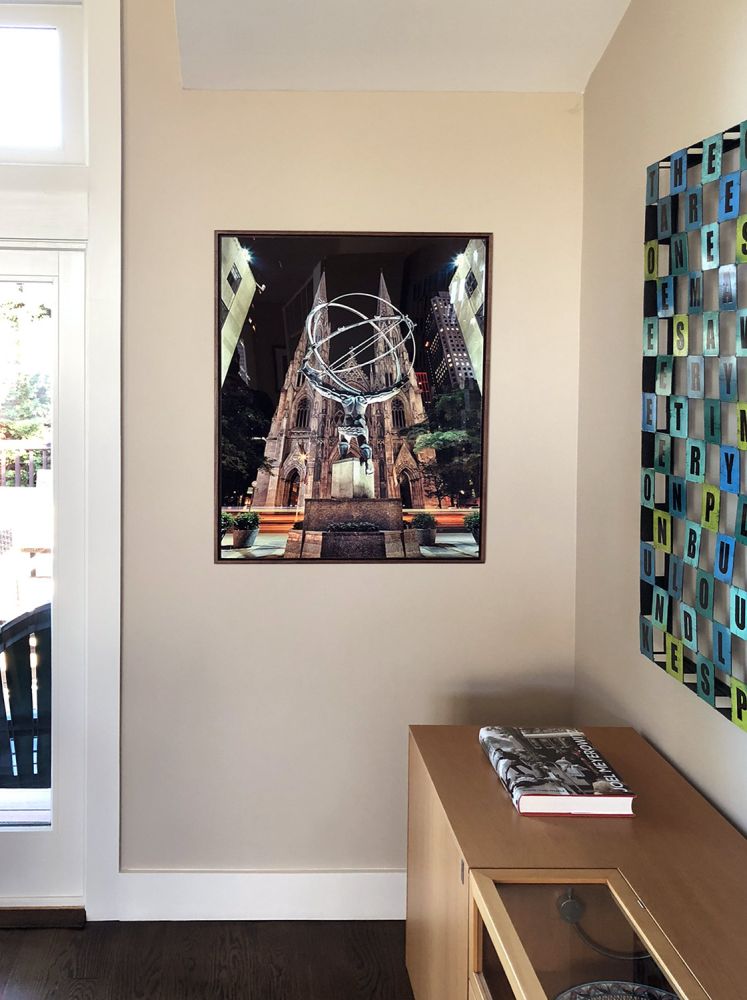 A 30 inch limited edition print of 'Rockefeller Center Atlas and St. Patrick's Cathedral at Night' by photographer Andrew Prokos with an acrylic floater frame
