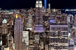 A high-definition color cityscape photo of Midtown Manhattan, the Empire State Building, and the Tribute in Light as seen from Rockefeller Center at night looking toward the south, New York City. Captured on the 20th Anniversary of September 11th on 9/11/2021. Large-format fine art prints of this photo are available up to 96 inches in height.