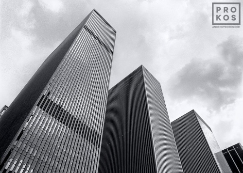 A black and white architectural photo of the skyscrapers of Rockefeller Center along Avenue of the Americas, NYC