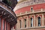 An architectural view of the exterior Royal Albert Hall in London and adjacent buildings on Kensington Gore road.