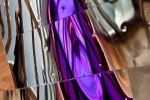 An abstract fine art photo of colorful reflections in tones of purple and silver on a polished metal surface. From the series "Audacity of Color"