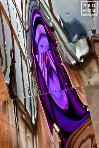 An abstract fine art photo of colorful reflections in tones of purple and silver on a polished metal surface. From the series "Audacity of Color"