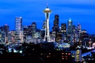 A panoramic cityscape photo of the Seattle skyline at dusk