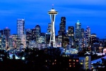 A panoramic cityscape photo of the Seattle skyline at dusk