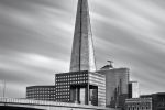 A black and white view of The Shard skyscraper and London Bridge captured in an eight minute long exposure by photographer Andrew Prokos.