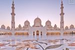 A view of Sheikh Zayed Grand Mosque illuminated by the rosy colors of the dusk sky, Abu Dhabi, United Arab Emirates. High-definition fine art prints of this photo are available up to 72 inches in width.
