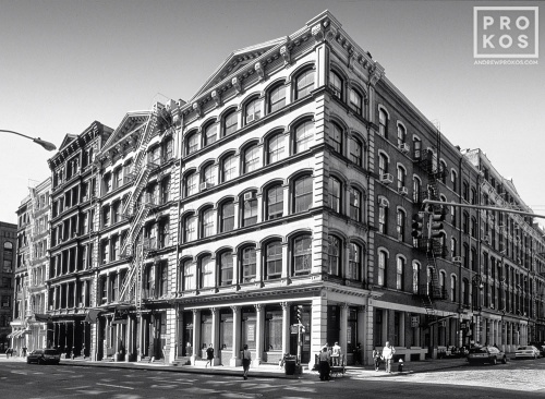 A black and white photo of the classic loft buildings at the intersection of Broome and Wooster streets in Soho, New York City
