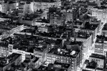 A panoramic fine art photo of the rooftops of Soho New York City at night in black and white.