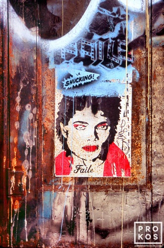 Graffiti and a poster of Michael Jackson the door of a Soho loft building, New York City