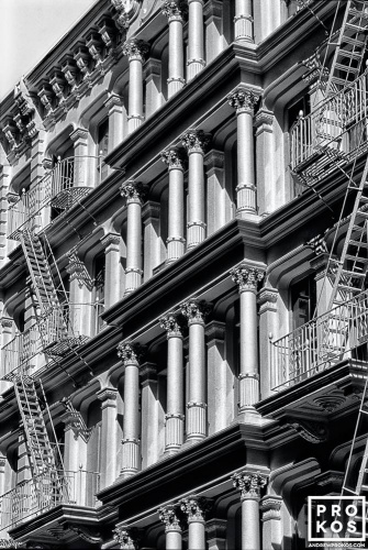 A black and white architectural photo of the ornate cast iron facade of a Soho loft building, New York City. Framed fine art prints of this photo are available in various sizes, please inquire. 