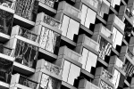 A black and white architectural photo of the windows from spiral contemporary architecture. Fine art prints of this photo are available up to 72 inches in height and framed in wood, metal, and acrylic styles. 