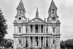 A black and white photo of the west front of St. Paul's Cathedral in London with visitors attending Sunday mass congregating in front of the Cathedral, United Kingdom. Multiple long-exposure images were captured and merged into a single seamless high-definition image to create this photo. Limited edition fine art prints of this photo are available up to 72 inches in width.