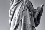 A vertical panoramic view of the Statue of Liberty in black and white, New York City.