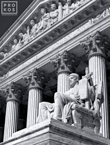 A black and white fine art architectural photo of the U.S. Supreme Court with Guardian of Law statue in the foreground, Washington DC