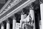 Facade of the US Supreme Court in black and white, with the Guardian of Law statue in the foreground, Washington DC