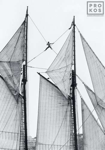 A sailor perched in the rigging of a two-masted schooner on the Hudson River
