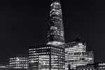 A black and white view of the Shard tower and London Bridge captured at night by photographer Andrew Prokos. High-definition fine art prints of this photo are available up to 80 inches in height.