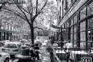 A black and white street scene photo with cafe patrons in Tribeca, New York City. Fine art prints of this photo are available framed in various styles. 