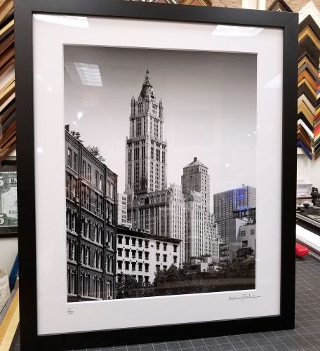 A framed black and white architectural fine art print of 'Tribeca Skyline With Woolworth Building II' by photographer Andrew Prokos