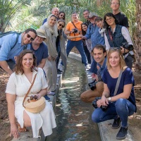 A delegation of photographers, architects, museum curators, writers, and UAE Embassy staff on an outing at Al Ain Oasis in Abu Dhabi