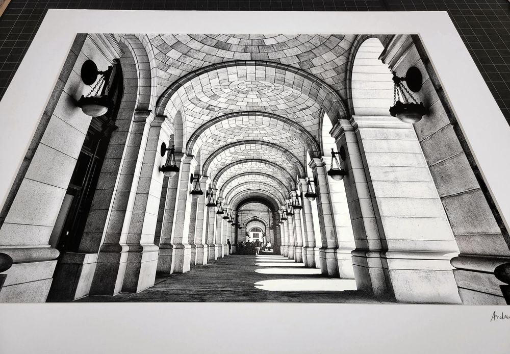 A matted black and white architectural fine art print of 'Union Station Arcade' by photographer Andrew Prokos