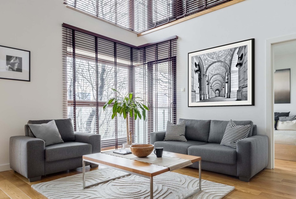 A black and white framed architectural photo of Union Station's Grand Concourse, Washington DC as seen in an upscale home interior. Fine art prints of this photo are available up to 80 inches and framed in contemporary styles. 