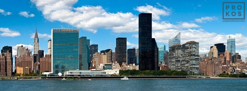A panoramic skyline photo of East Midtown Manhattan, the East River, and the United Nations buildings in New York City