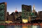A panoramic cityscape photo of the Midtown Manhattan skyline and the United Nations at dusk, New York City.