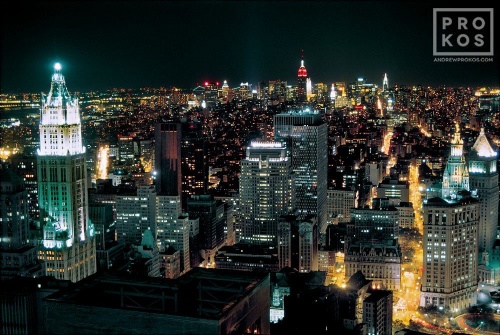 An aerial view of Lower Manhattan at night showing the Woolworth Building and the Municipal Building, New York City