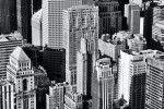 A black and white cityscape photo of the skyscrapers of Midtown Manhattan as seen from the top of the Empire State Building, New York City