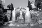 A black and white photo of the famous Organ Fountain in the gardens of the Villa D'Este, Tivoli, Italy