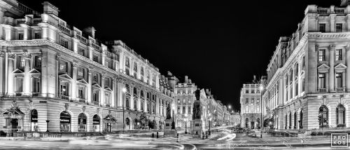 A black and white panoramic view of Waterloo Place and Pall Mall at night, London, United Kingdom. Large-scale limited edition prints of this photo are available up to 120 inches in width.