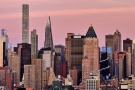 A close-up skyline featuring the skyscrapers of Midtown Manhattan bathed in the rosy hue of dusk. Large-format fine art prints of this photo are available up to 72 inches in width and framed in various wood, metal, and acrylic styles. 