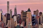 A close-up skyline featuring the skyscrapers of Midtown Manhattan bathed in the rosy hue of dusk. Large-format fine art prints of this photo are available up to 72 inches in width and framed in various wood, metal, and acrylic styles. 