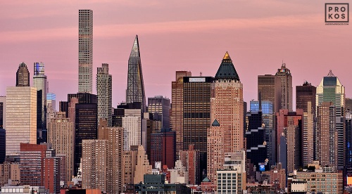 A close-up skyline featuring the skyscrapers of Midtown Manhattan bathed in the rosy hue of dusk. Large-format fine art prints of this photo are available up to 72 inches in width and framed in various wood, metal, and acrylic styles. 