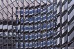 Abstract photography of warped building reflections on a glass facade in tones of blue, black, grey, and silver in London, United Kingdom. Large-format limited edition prints of this photo are available up to 80 inches in width.