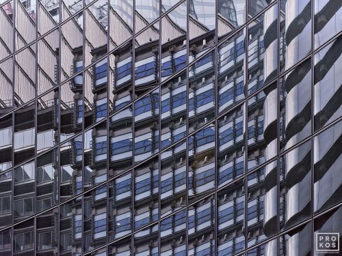 Abstract photography of warped building reflections on a glass facade in tones of blue, black, grey, and silver in London, United Kingdom. Large-format limited edition prints of this photo are available up to 80 inches in width.