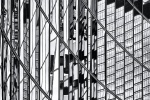 An abstract black and white photo of warped reflections of modern architecture reflected on a black glass facade in London, United Kingdom. Large-format limited edition prints of this high-definition photo are available up to 80 inches in height and framed in contemporary styles. 