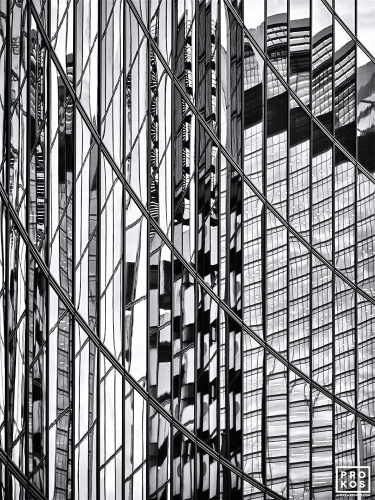 An abstract black and white photo of warped reflections of modern architecture reflected on a black glass facade in London, United Kingdom. Large-format limited edition prints of this high-definition photo are available up to 80 inches in height and framed in contemporary styles. 