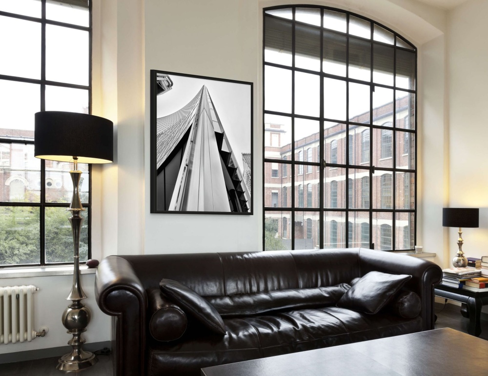 A black and white framed photo of the Willis Building in London seen in a luxury loft interior. High-definition fine art prints of this photo are available up to 72 inches in height.