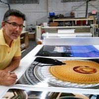 Photographer Andrew Prokos signing large scale fine art prints of Washington DC for Hyatt Hotels.