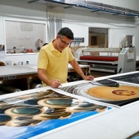 Photographer Andrew Prokos signing large scale fine art prints of Washington DC for Hyatt Hotels.
