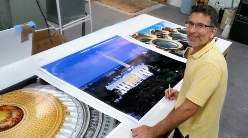 Photographer Andrew Prokos signing large scale fine art prints of Washington DC for Hyatt Hotels.