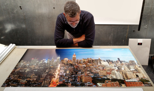 Photographer Andrew Prokos preparing a 50" limited edition print from his award-winning photo series Night & Day.